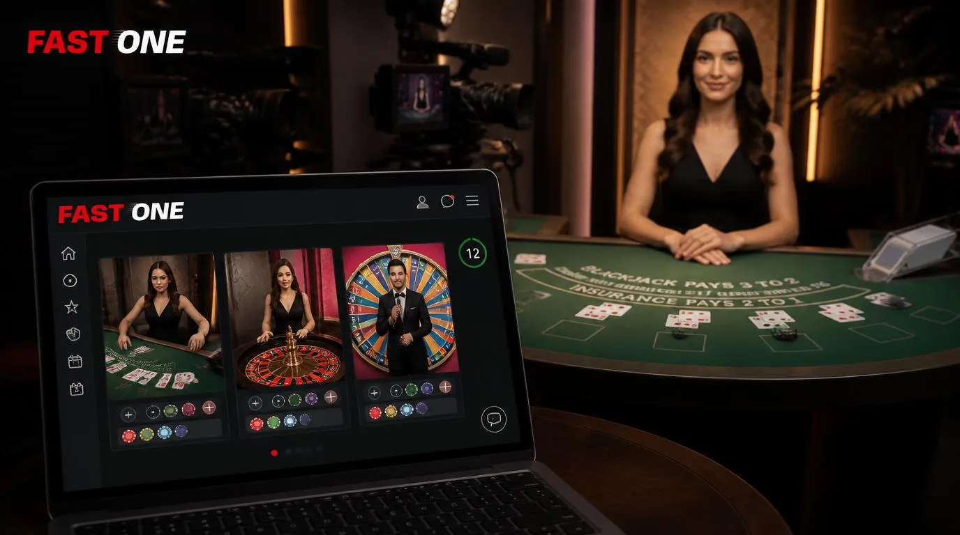Krupierka przy stole do blackjacka w studiu live oraz ekran z ruletką i teleturniejem